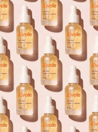 Youth Elixir bottles on a soft pink background