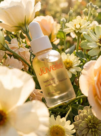 Youth Elixir nestled among cream flowers