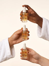 Three hands holding Youth Elixir