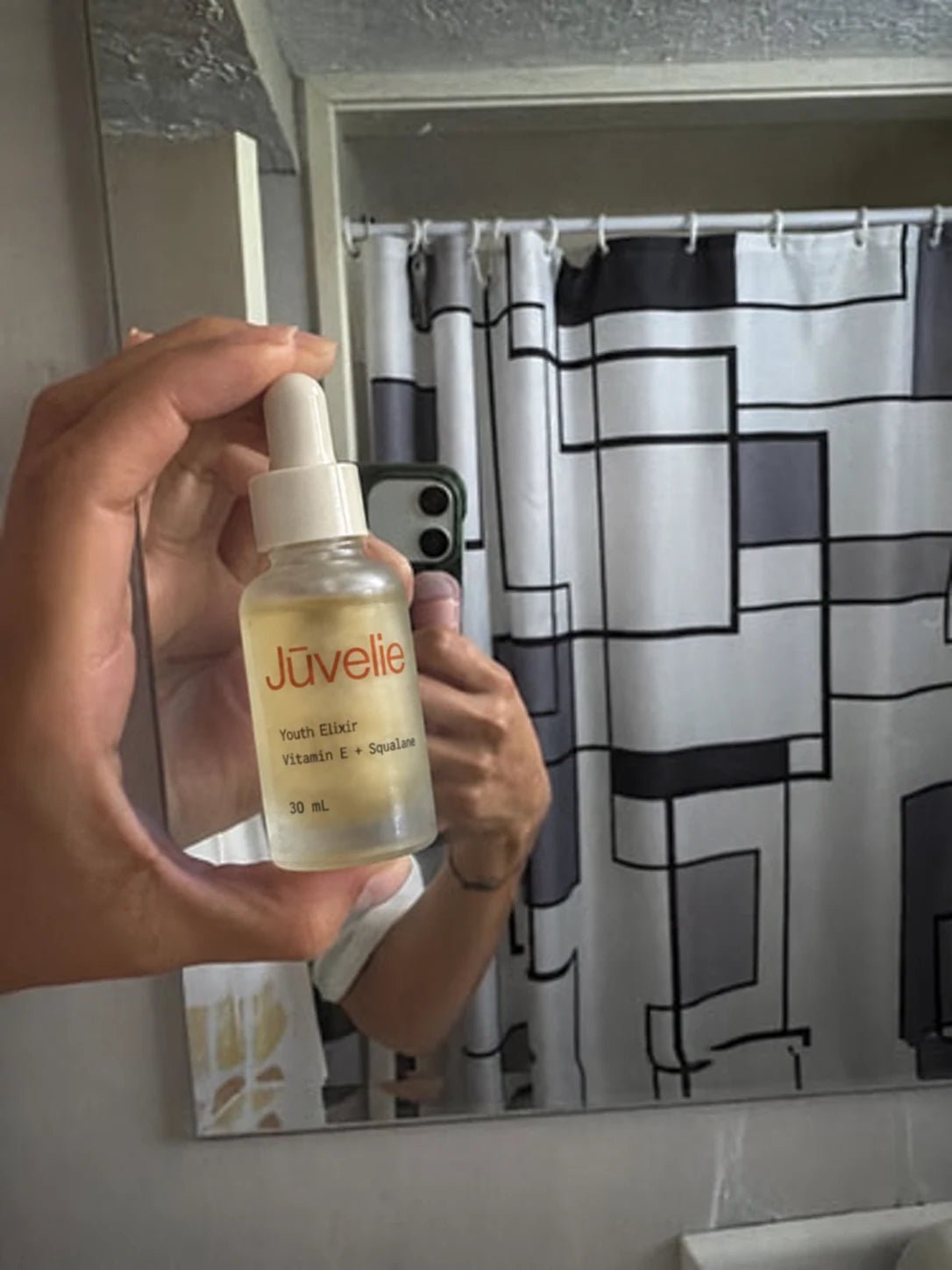 A quick mirror photograph of Youth Elixir in a bathroom